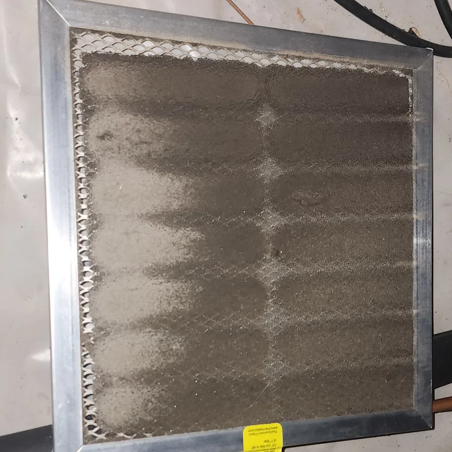 Severely clogged, dust-caked air filter removed from a failed crawl space dehumidifier during an inspection in Cary NC