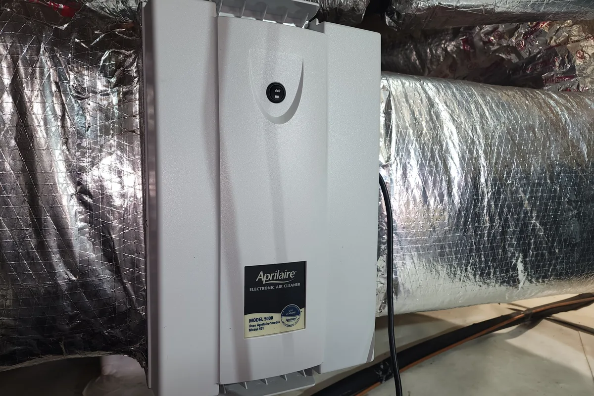 AprilAire whole-house air purifier installed on an HVAC system in a Raleigh NC home
